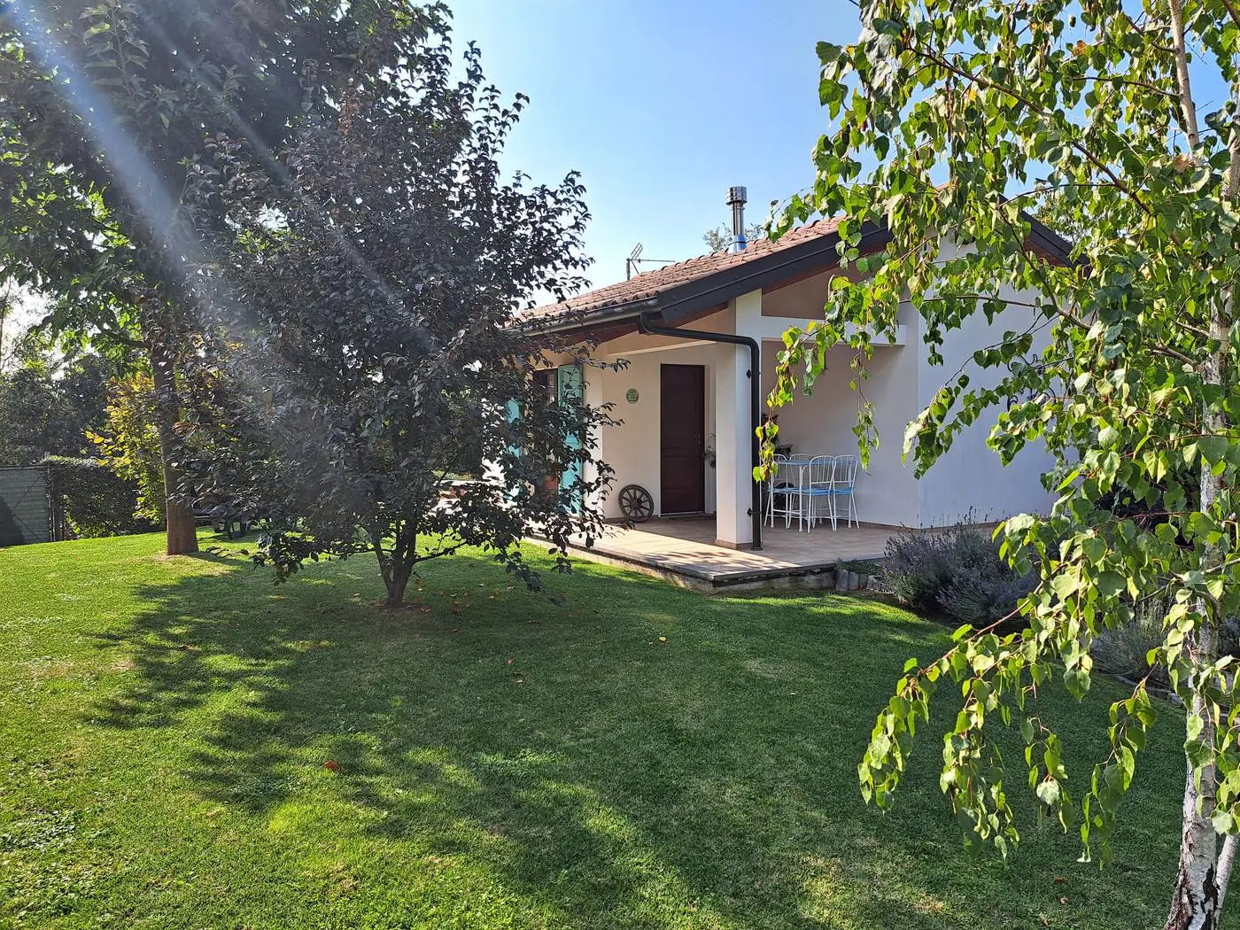 Il Ciabot di Rosa nestled in the garden among trees and lavender