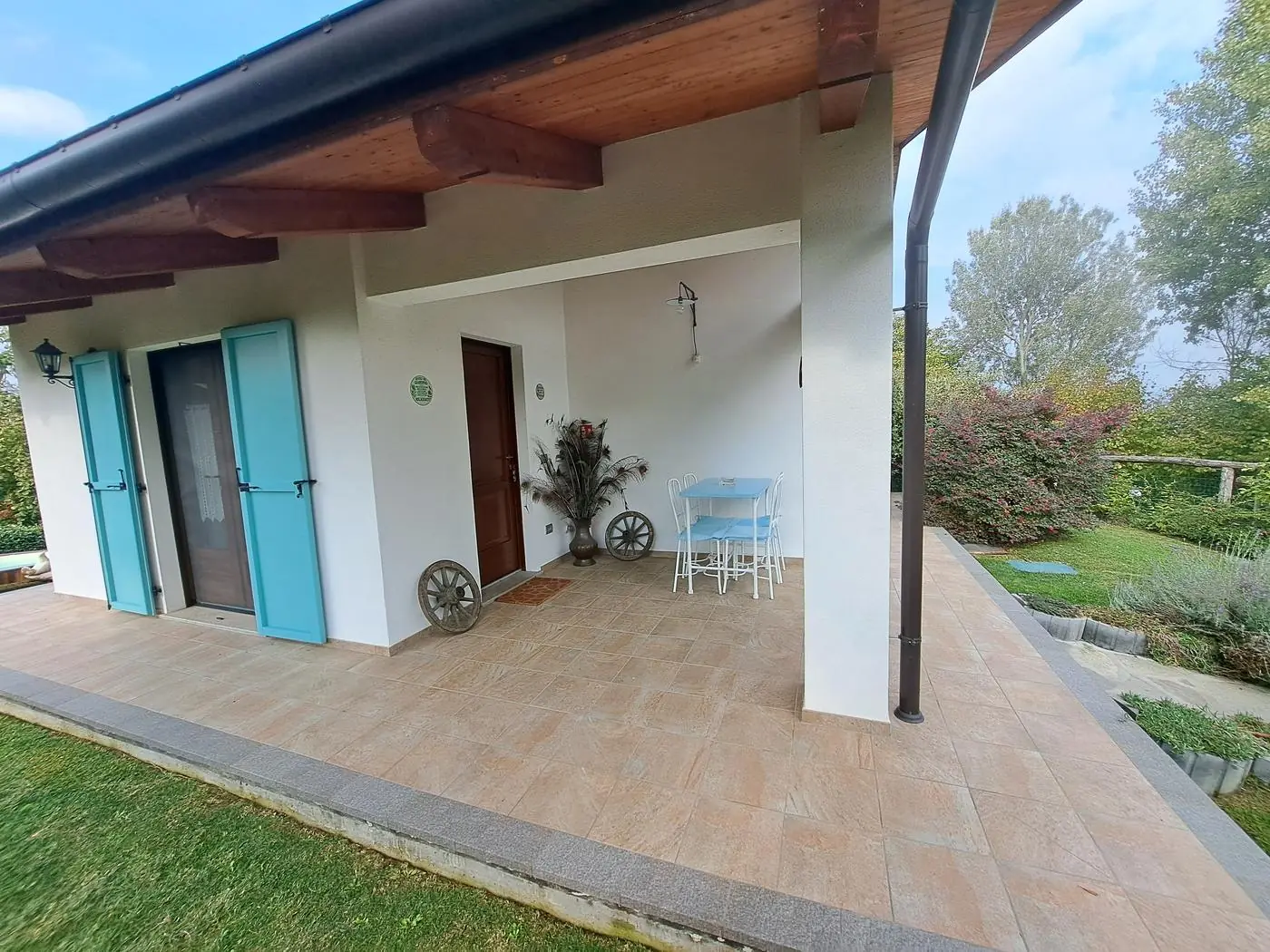 Covered porch with table and chairs for eating outdoors